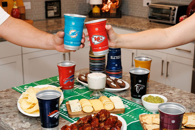 Friends raising officially licensed NFL Top Cup aluminum cups at a game day watch party
