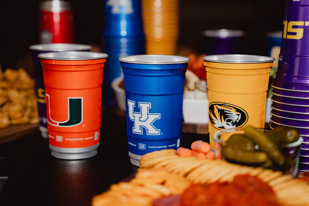 Miami, Kentucky and Missouri officially licensed college Top Cup aluminum cups set out on a game day table