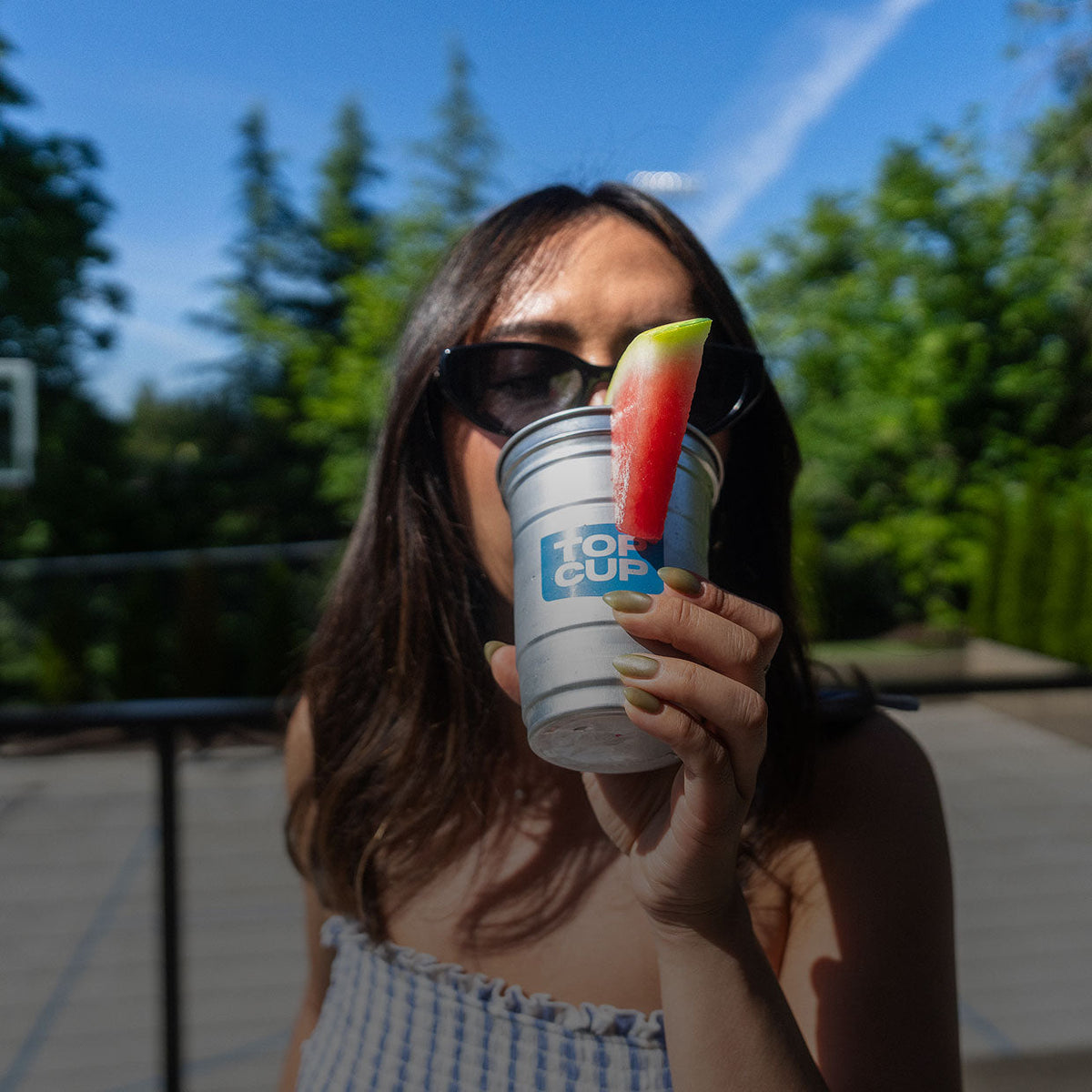 Person enjoying a cold Top Cup